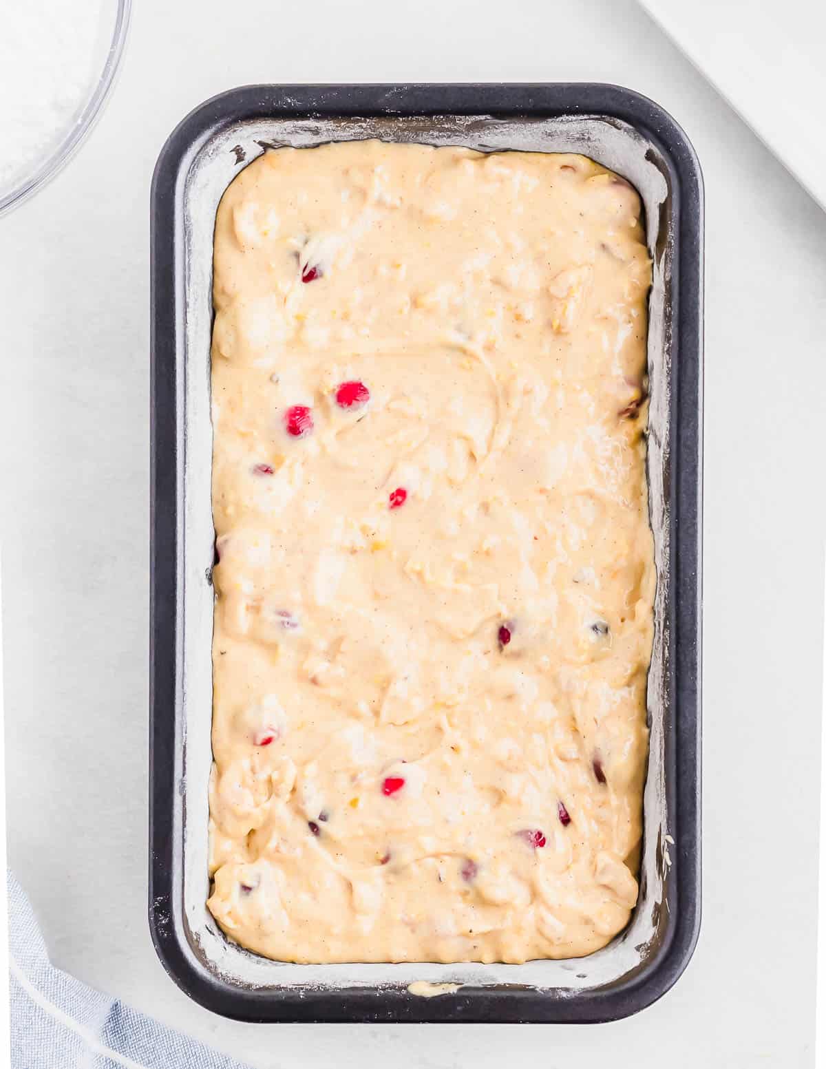 Cranberry orange bread batter in a bread tin before baking.