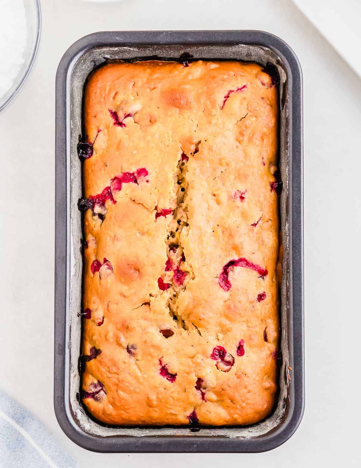 Baked cranberry orange bread in a loaf tin.
