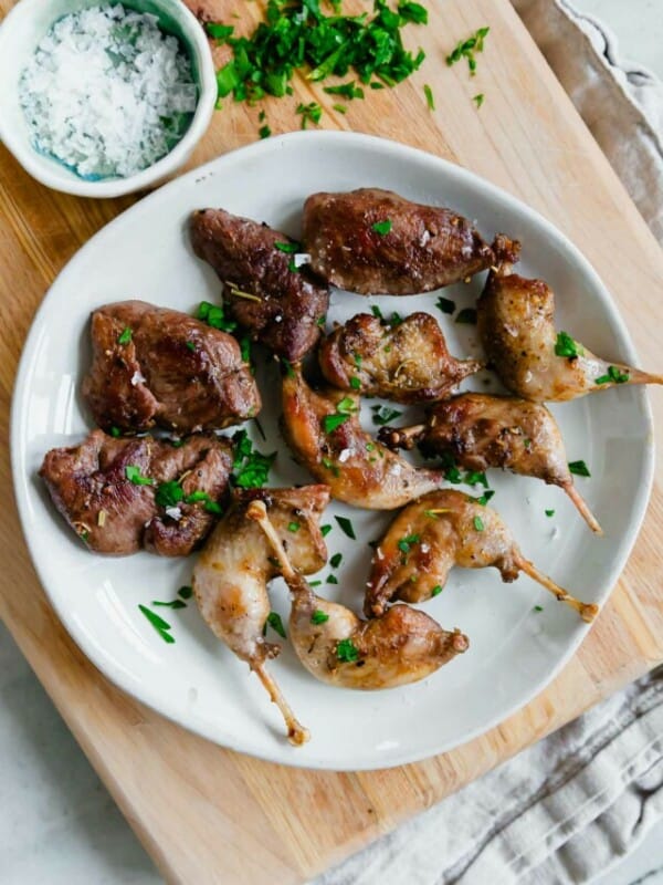 Chicken skewers on a plate with parsley.