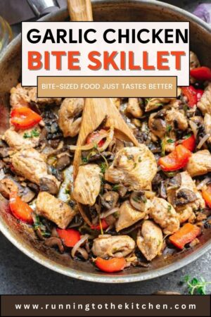 A skillet filled with chicken, peppers and mushrooms with a wooden spoon.
