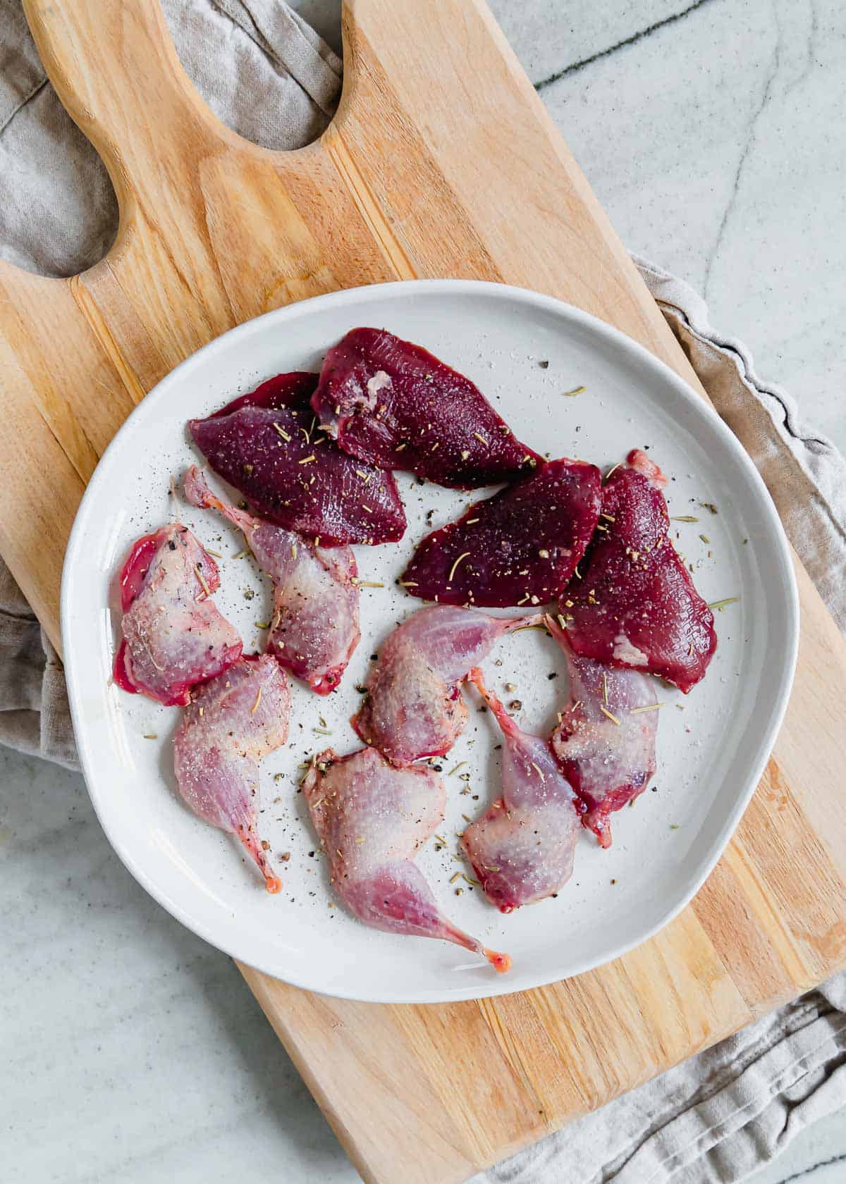 A plate of Woodcock breasts and thighs on a cutting board.