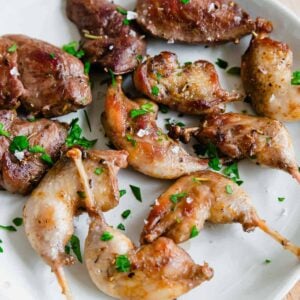 Timberdoodle pan-fried legs and breasts on a plate with salt and parsley.