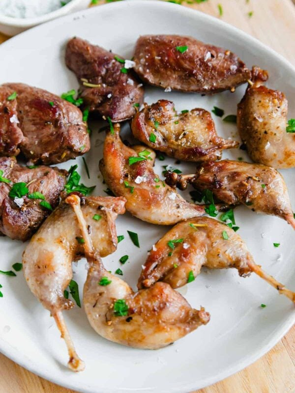 Timberdoodle pan-fried legs and breasts on a plate with salt and parsley.