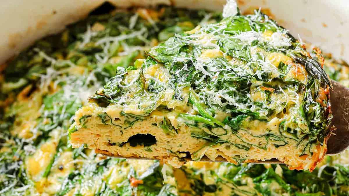 A slice of frittata with spinach and parmesan.