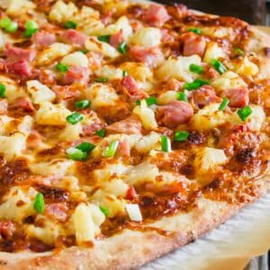 A hawaiian pizza with ham and pineapple.