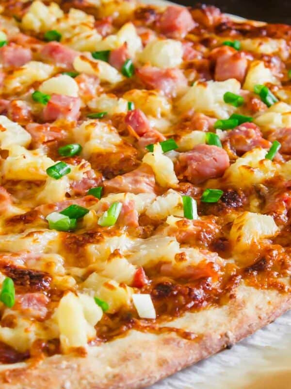 A hawaiian pizza with ham and pineapple.