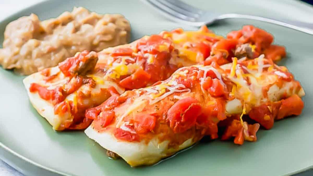 Mexican enchiladas on a green plate.