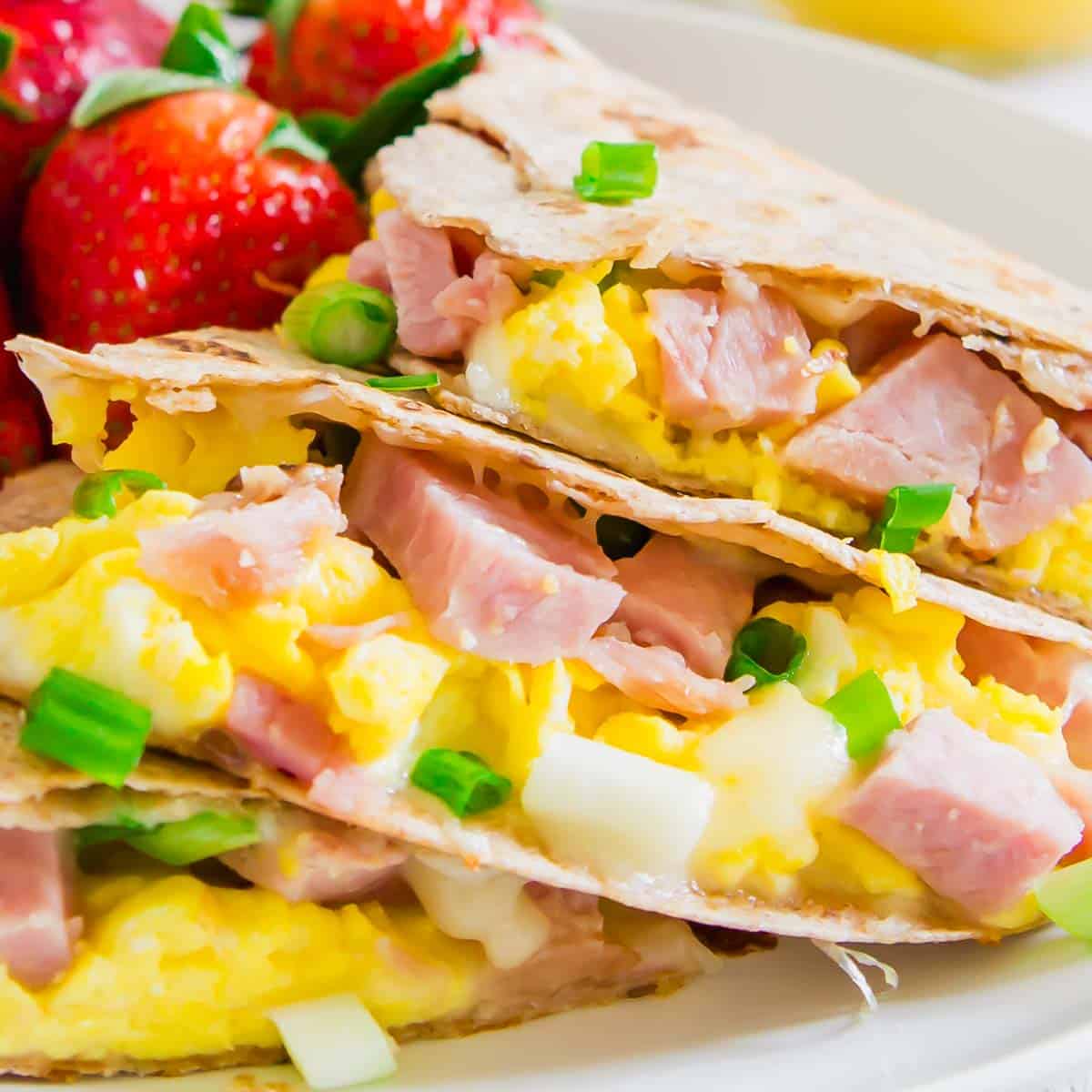 A plate of breakfast quesadillas with ham and eggs.