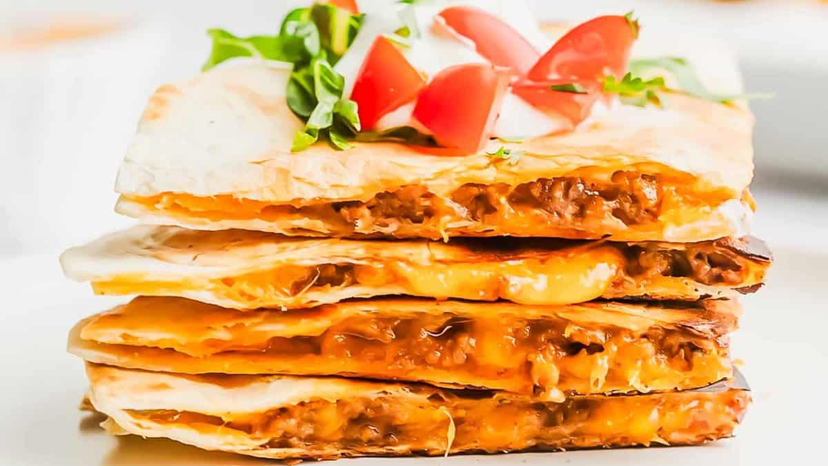 A stack of quesadillas on a plate.