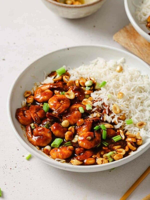 A bowl of rice and shrimp in a white bowl.