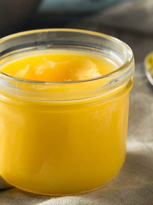 A jar with a spoon next to it.