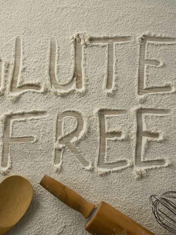The word gluten free spelled out on a piece of sand.