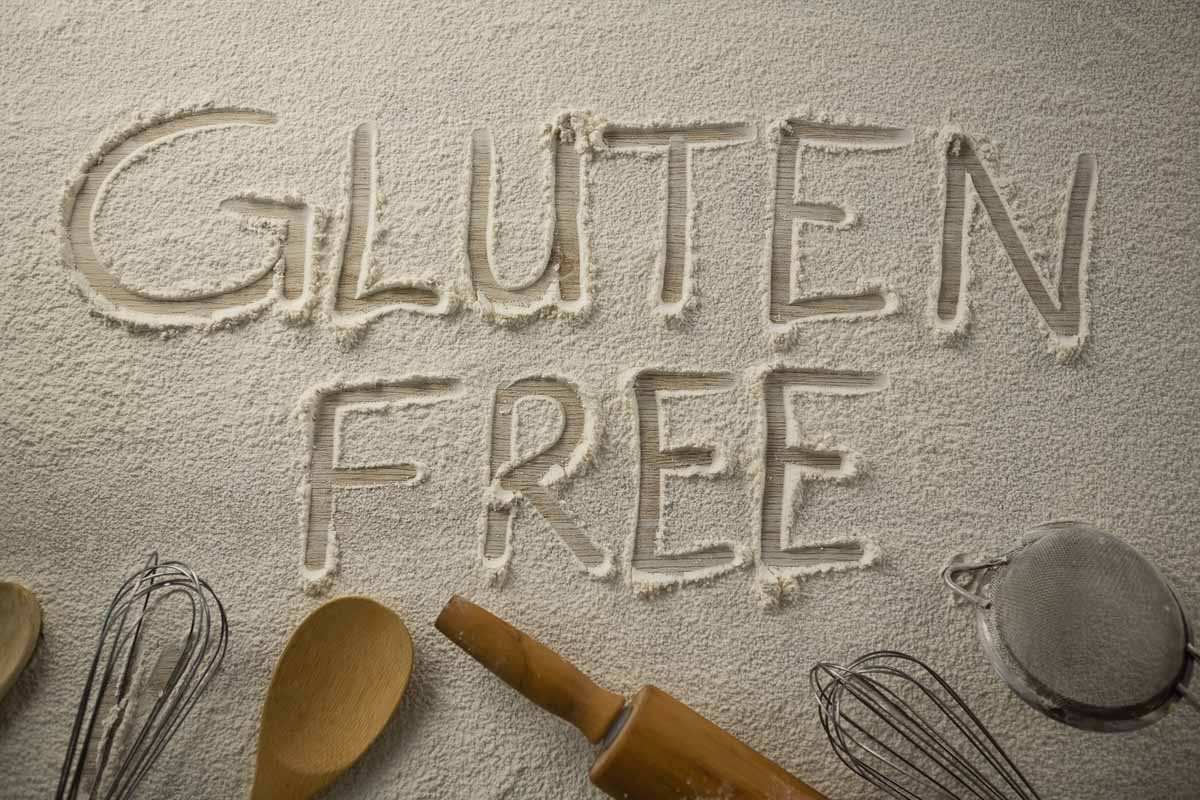 The word gluten free spelled out on a piece of sand.