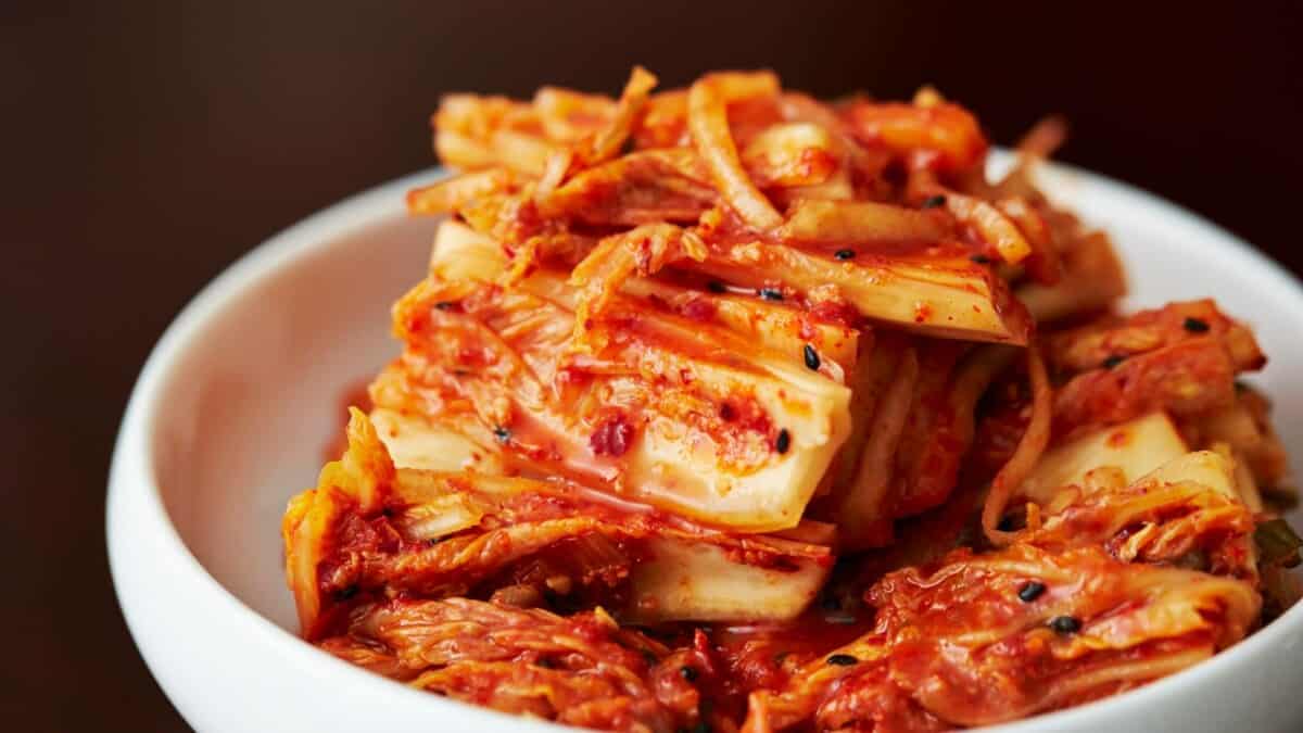 A bowl of korean kimchi in a wooden bowl.