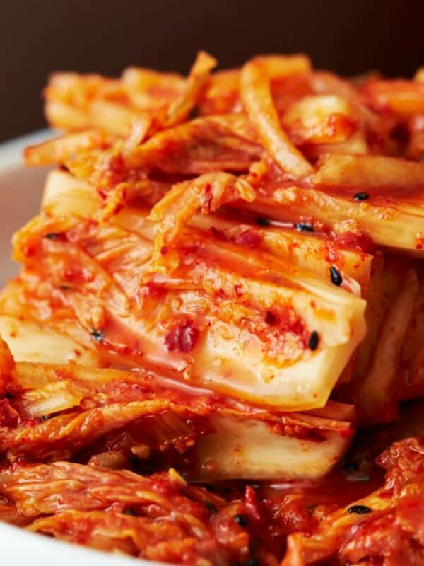 A bowl of korean kimchi in a wooden bowl.