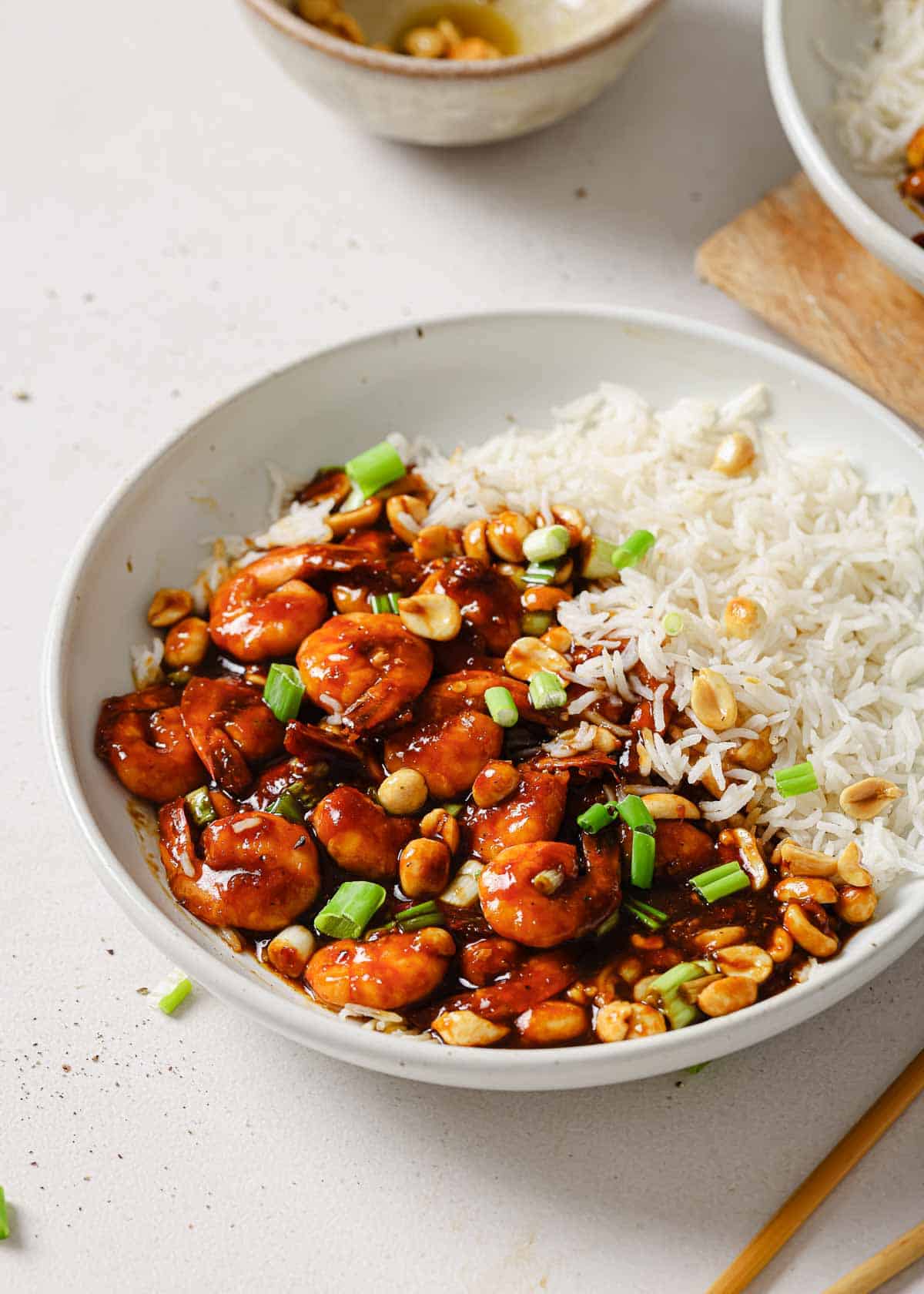 A bowl of rice with shrimp and peanuts in it.