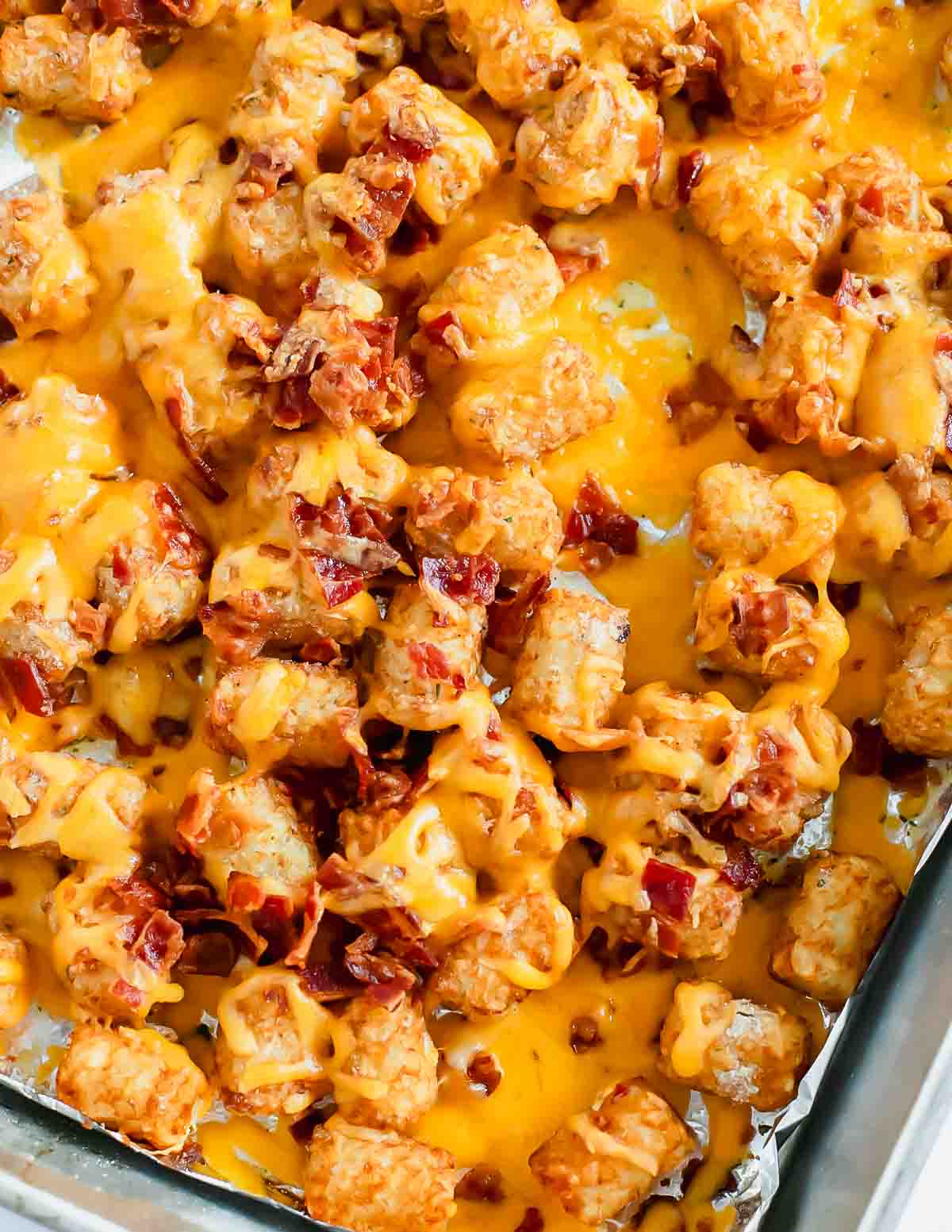 Cheesy tater tots in a baking dish.