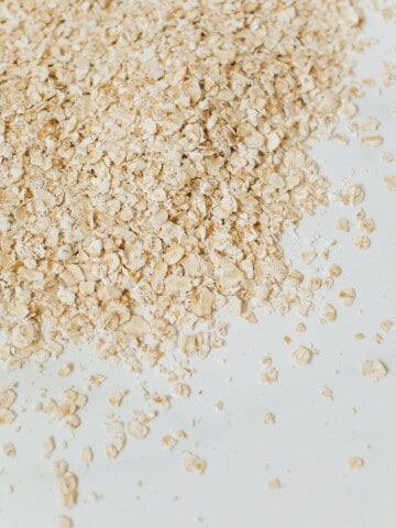 A pile of oats on a white surface.