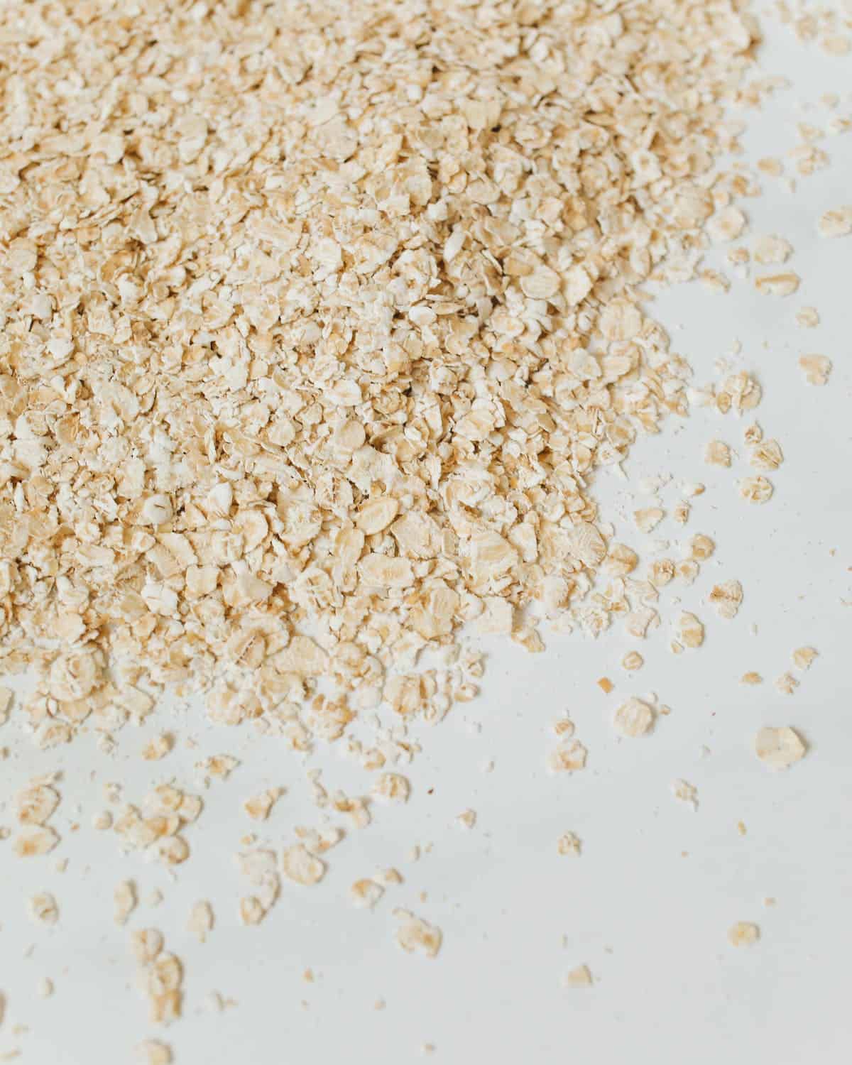 A pile of oats on a white surface.