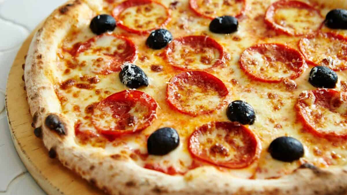 A pizza with black olives on top.