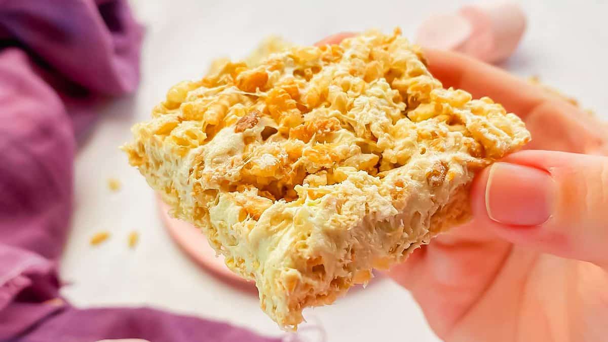 A person holding up a piece of granola bars.