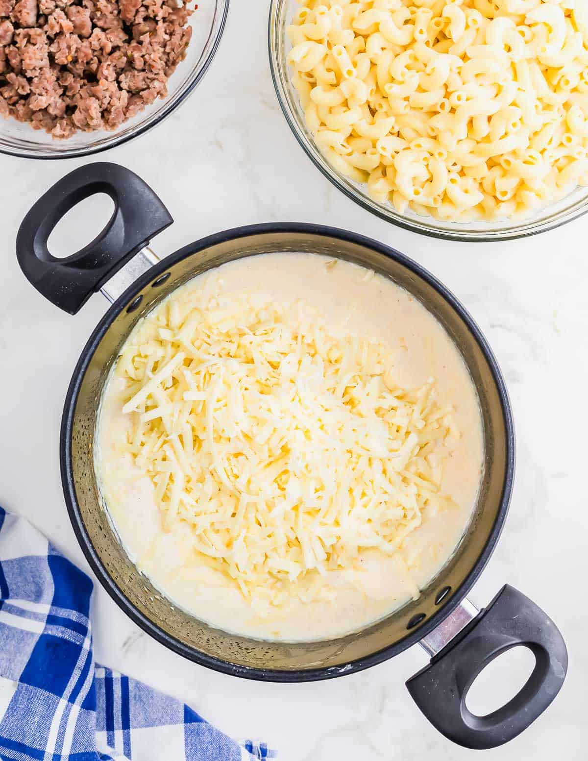 Making the cheese sauce in a pot for sausage mac and cheese.