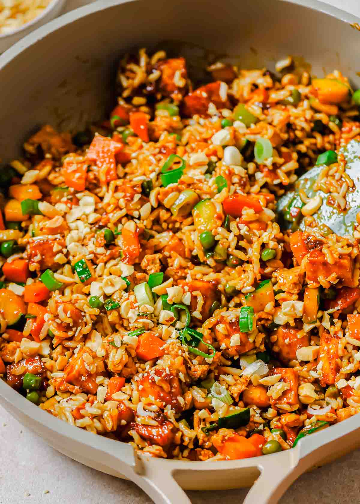 A skillet filled with tofu fried rice and vegetables.
