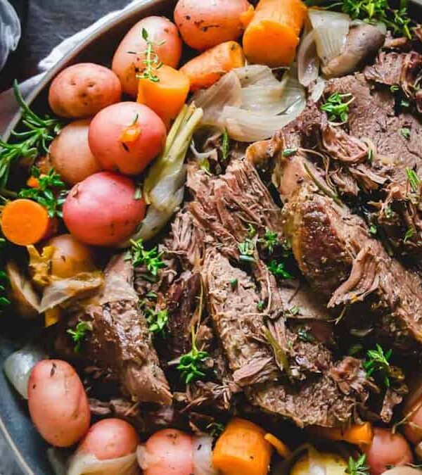 Venison roast with potatoes and carrots on a platter.