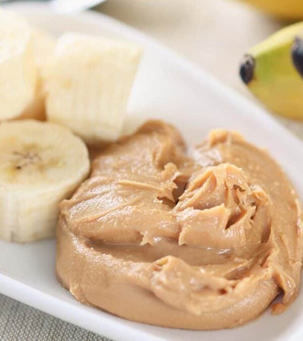 Peanut butter and bananas on a plate.