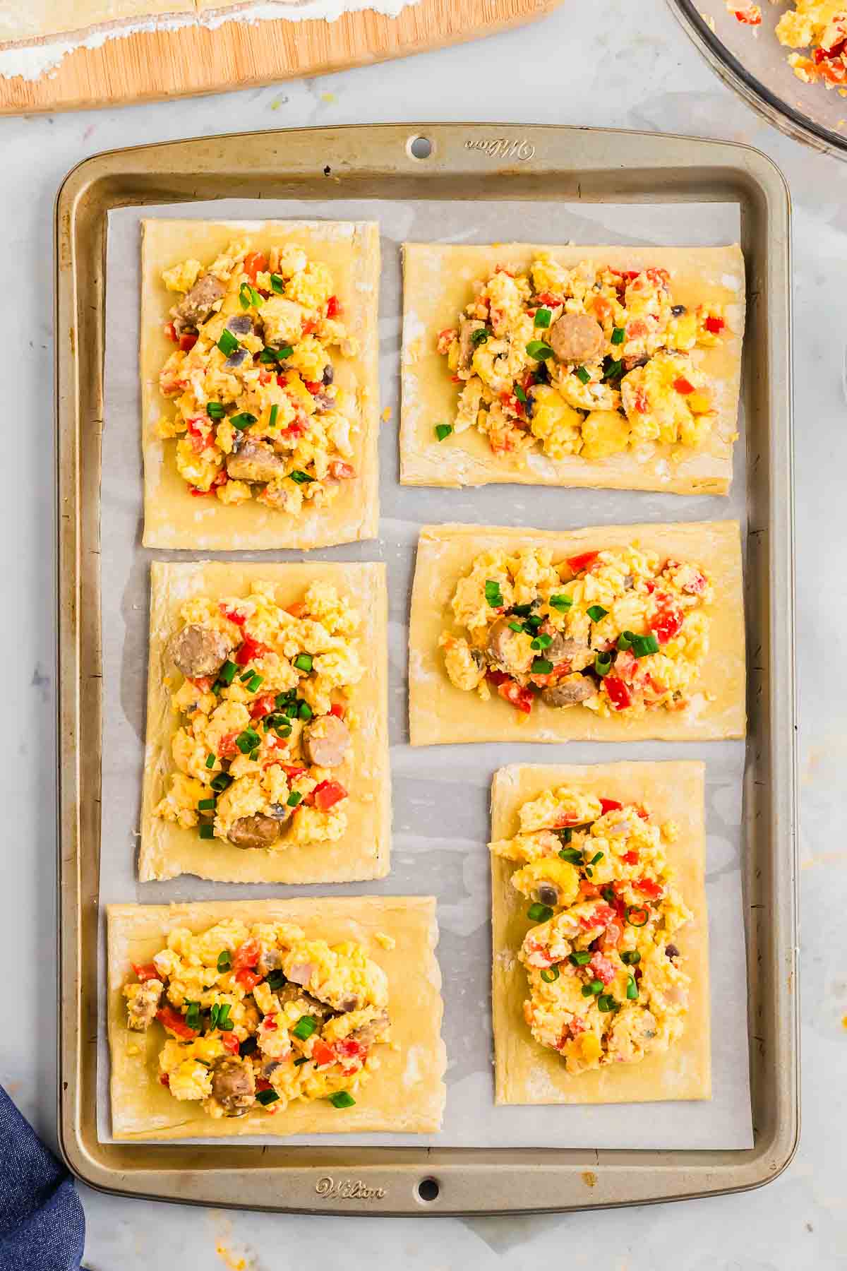 Making hot pockets with puff pastry on a baking sheet.