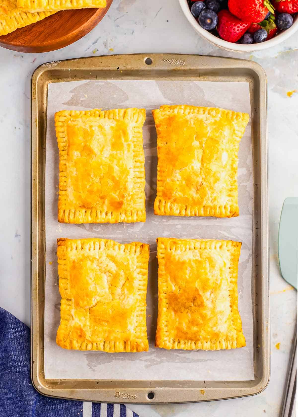 A baking sheet with a tray of hot pocket breakfast pastries.