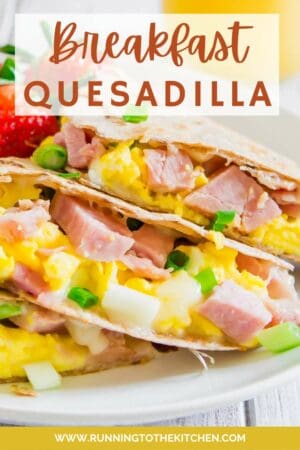 An easy breakfast quesadilla is presented on a plate with the text "breakfast quesadilla.