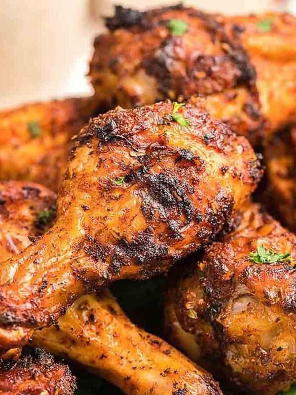 Grilled chicken wings on a plate with a lime wedge.