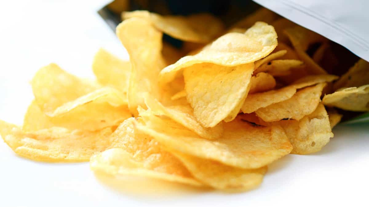 A bag of potato chips sitting on a white surface.