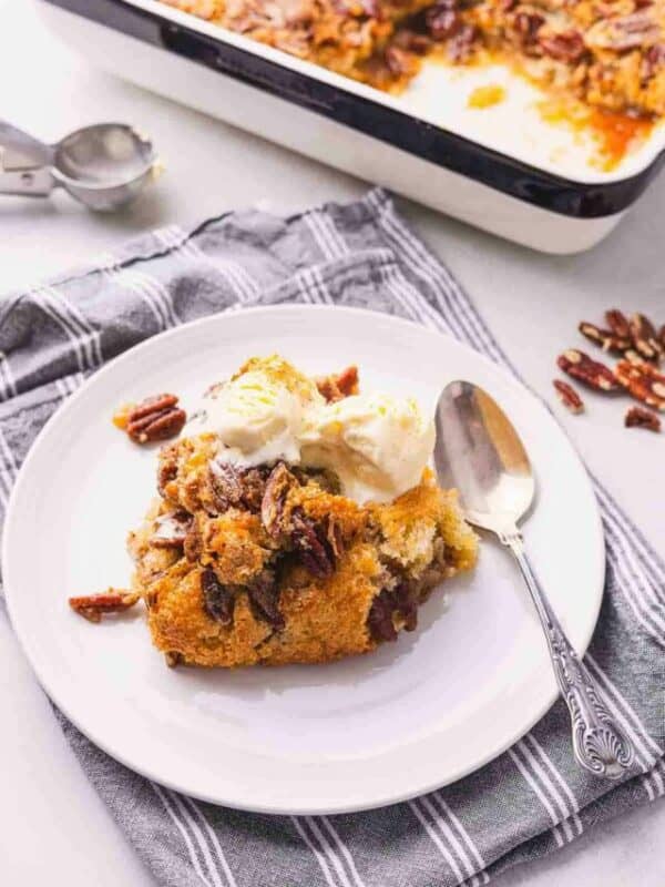 A plate with a piece of pecan bread and ice cream on it.