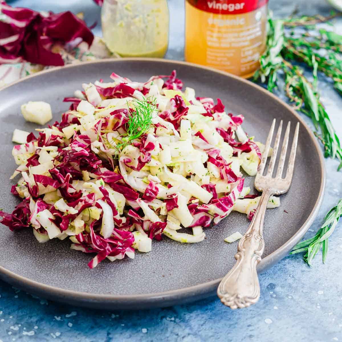 Chopped endive salad on a plate with a fork.