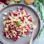 Endive, radicchio and fennel salad on a blue plate.
