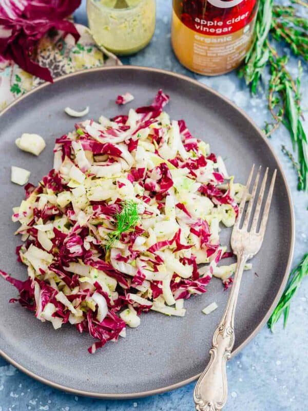 Endive, radicchio and fennel salad on a blue plate.