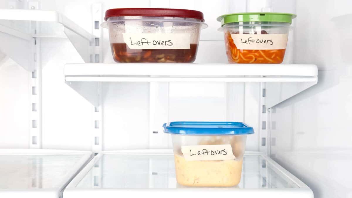 A refrigerator with several containers of food in it.