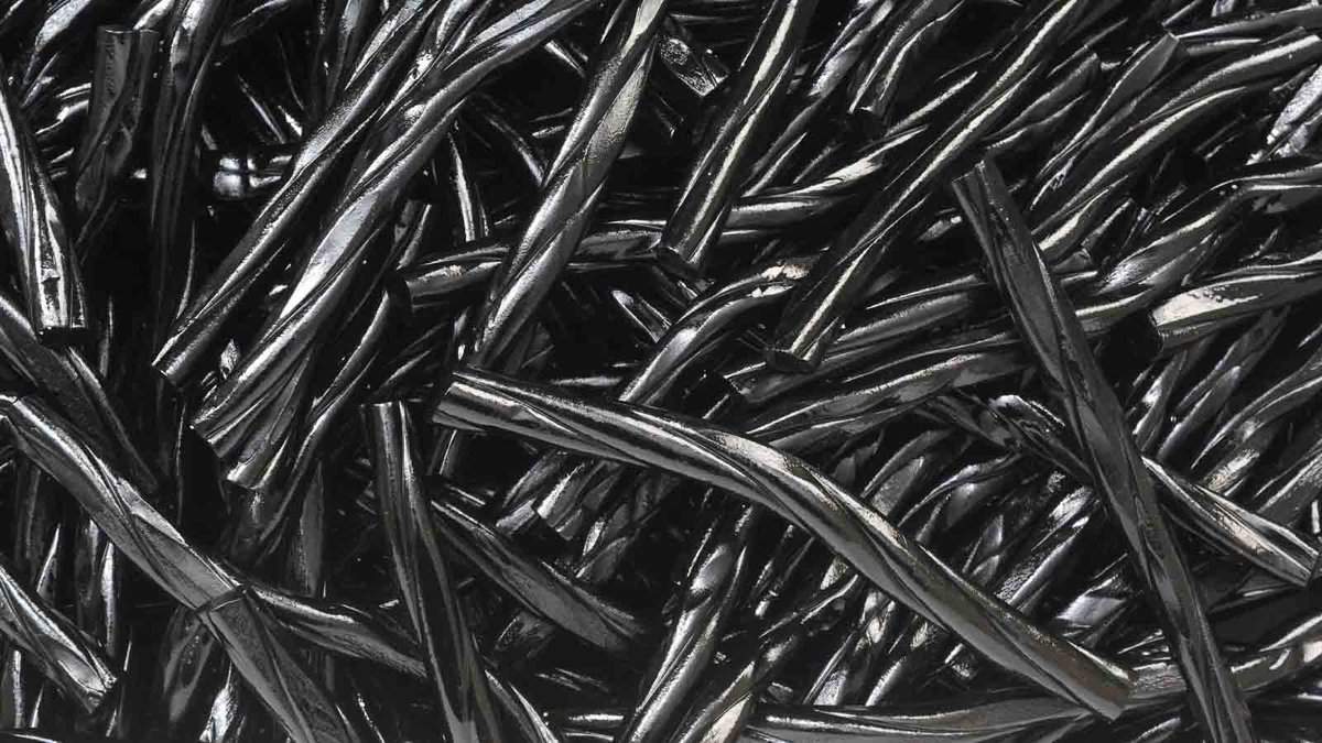 A pile of black plastic sticks on a white background.