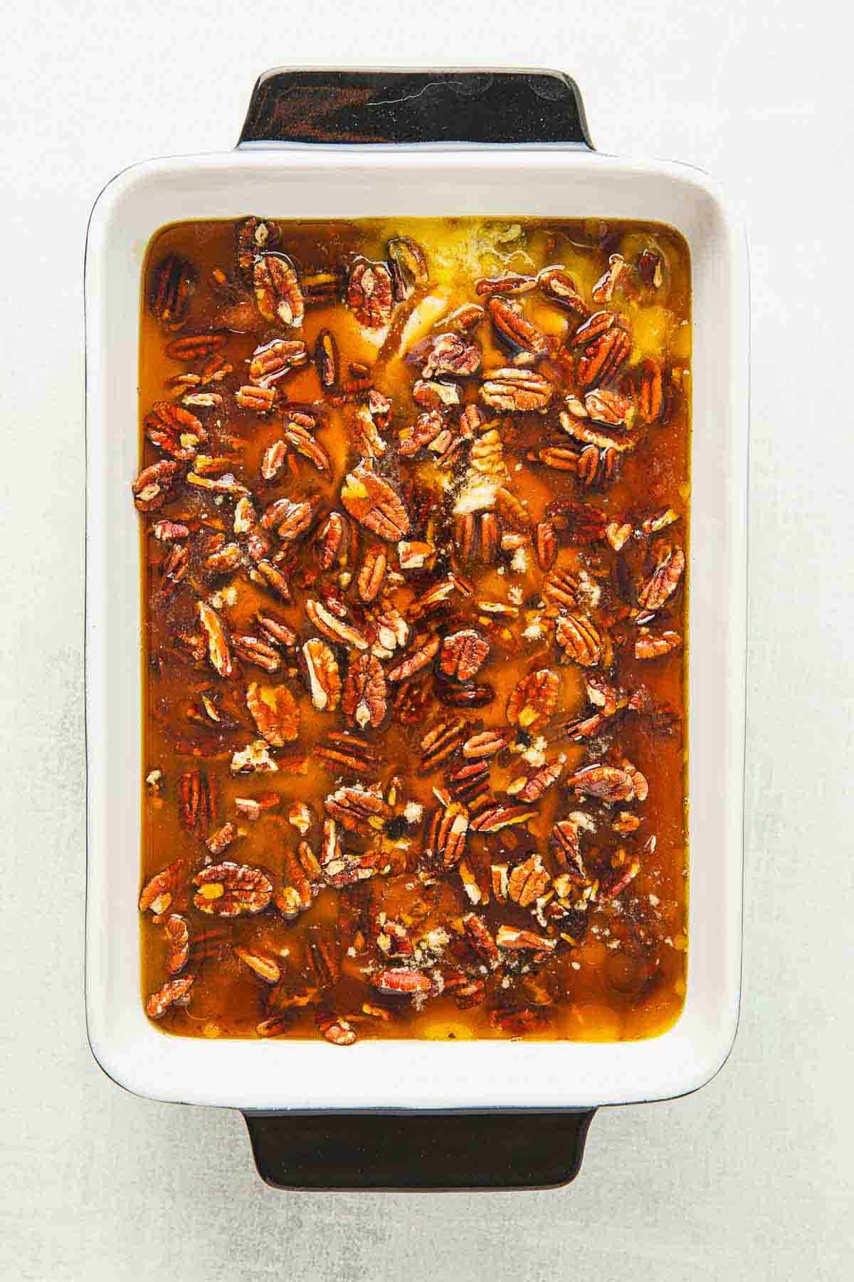 A casserole dish with pecans in it.