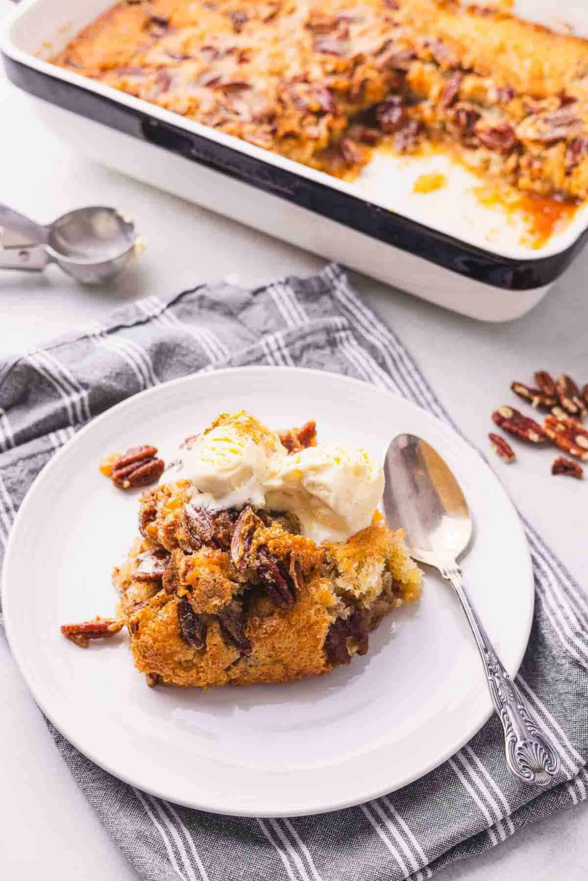 A plate with a piece of pecan cobbler on it.