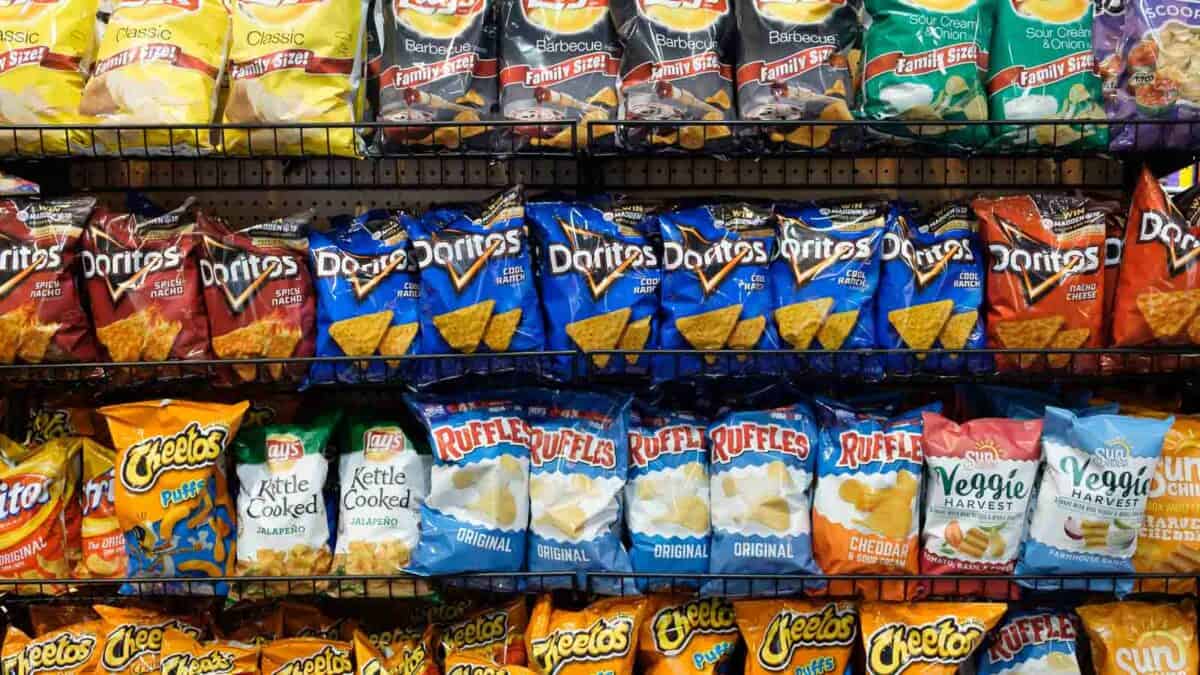 A rack of chips and snacks in a store.