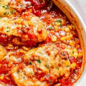 Close up of a casserole dish filled with baked salsa chicken and corn.