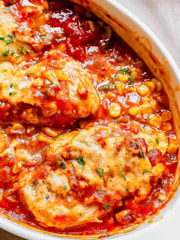 Close up of a casserole dish filled with baked salsa chicken and corn.