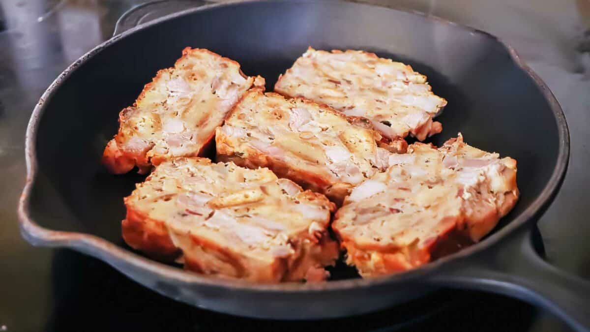 Sliced bread in a skillet on a stove top.