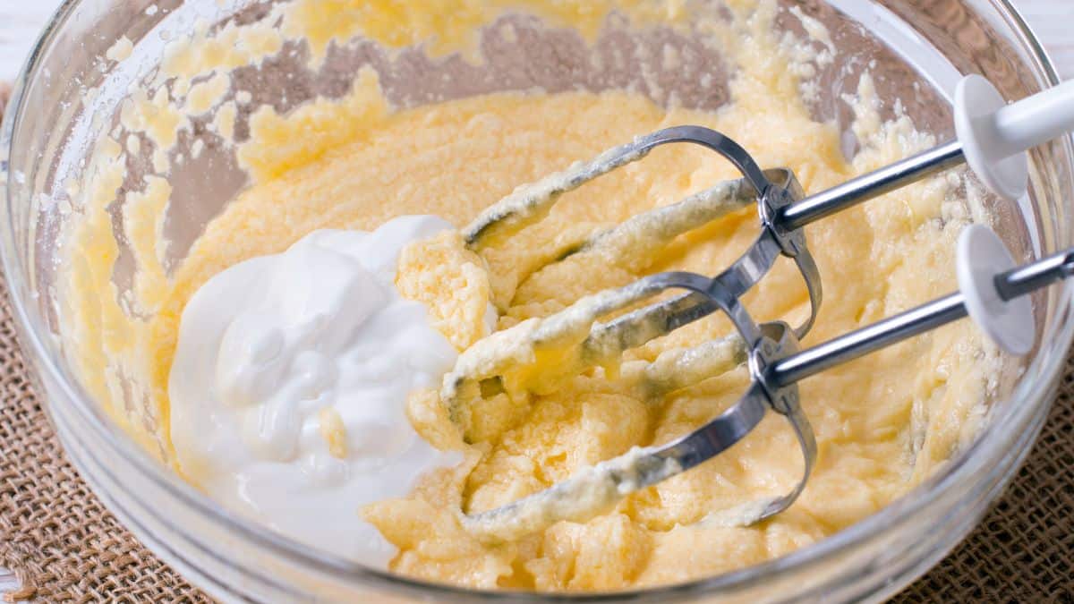 Whipped cream in a bowl with a whisk.