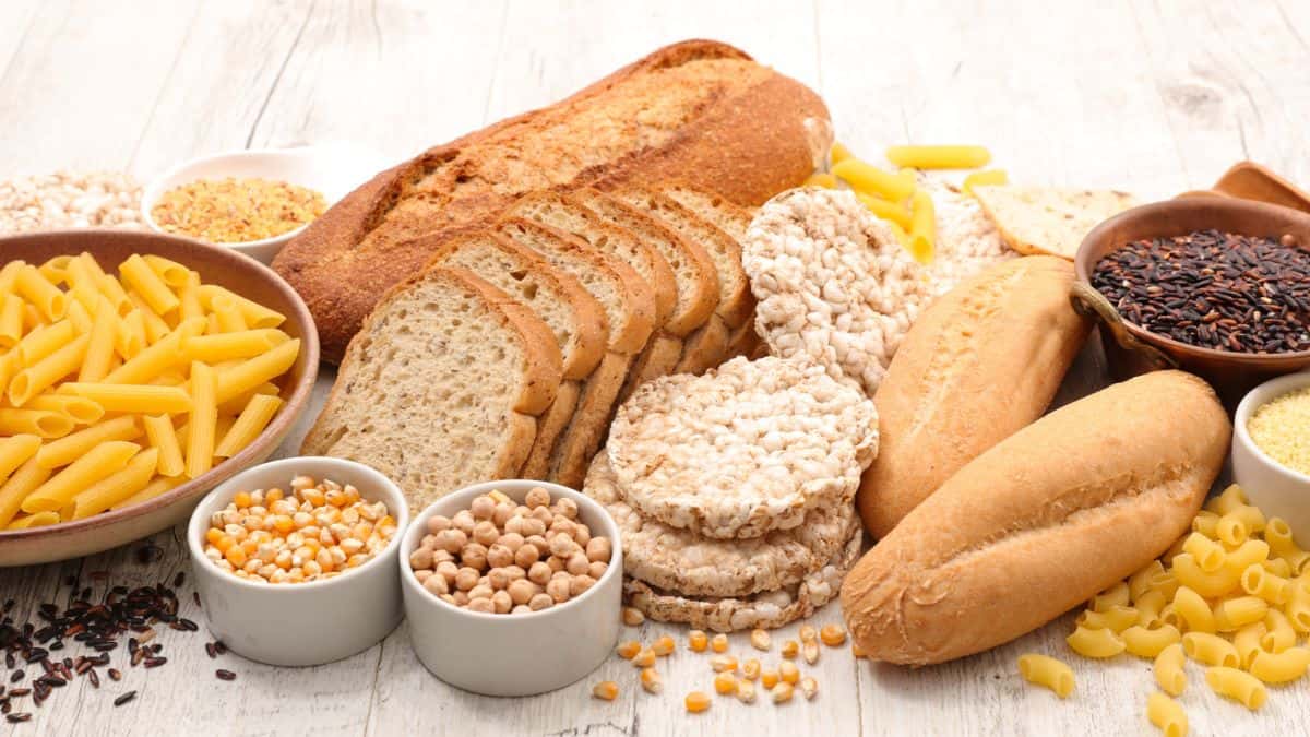 Bread, pasta and other foods on a wooden table.
