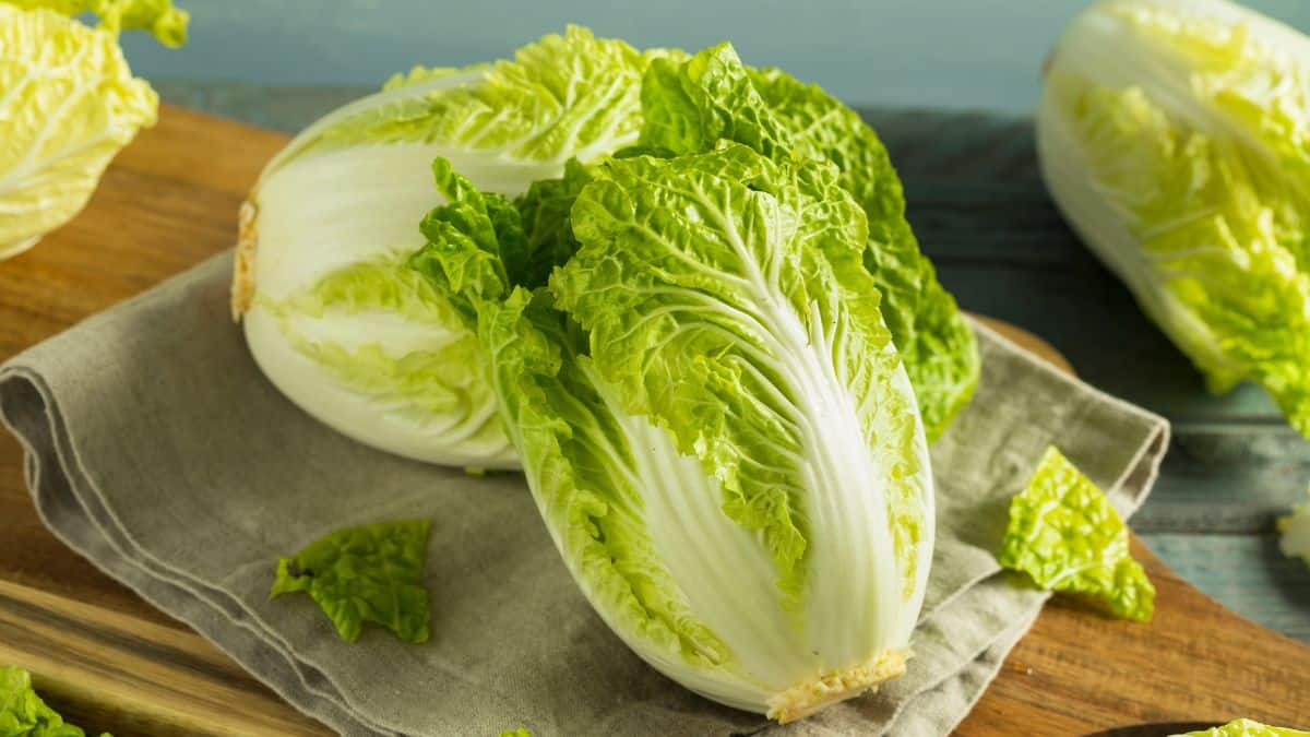 Chinese cabbage leaves on a wooden cutting board.