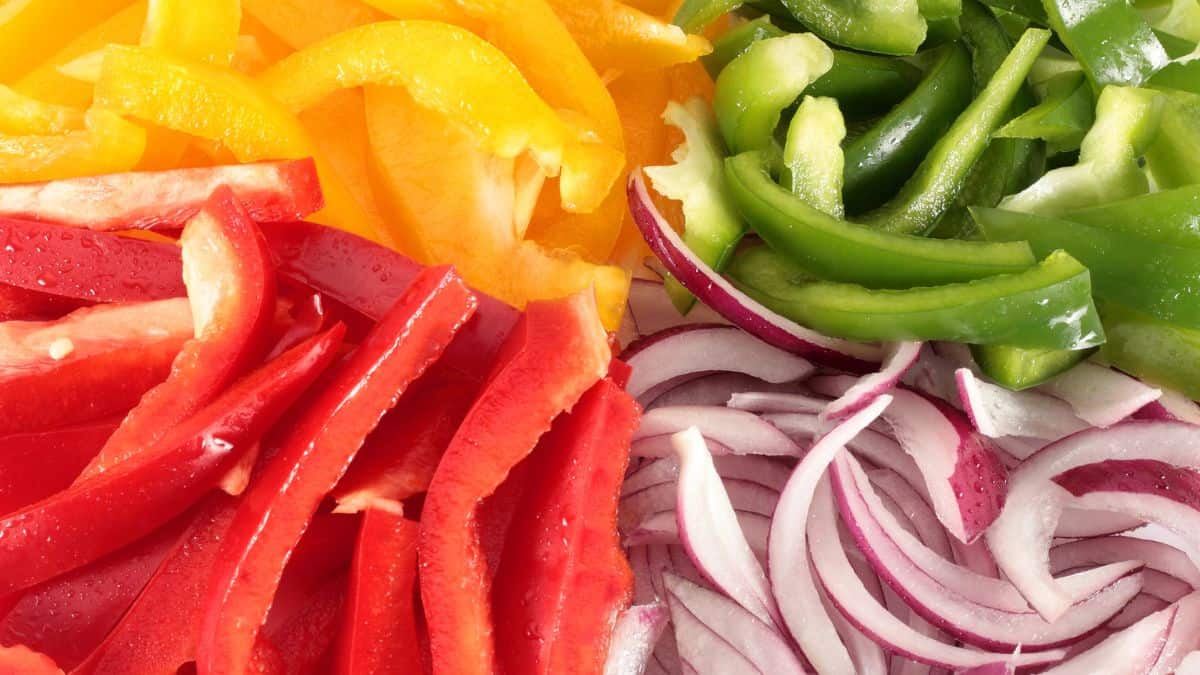 A close up of red, yellow, and green peppers.